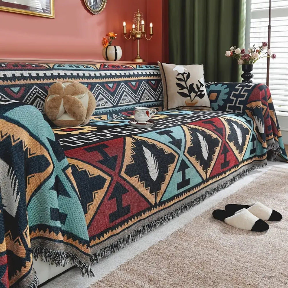 Copridivano boho con motivo geometrico azteco e nappine