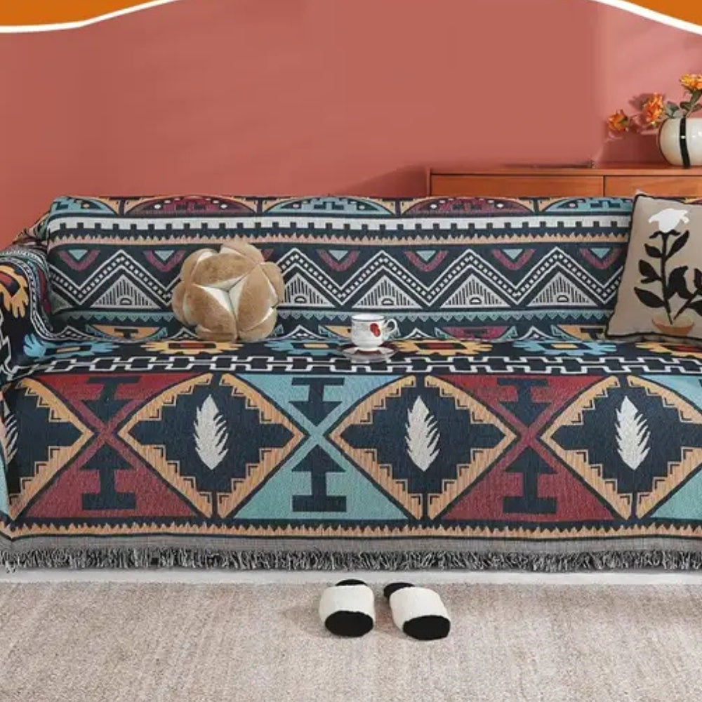 Copridivano boho con motivo geometrico azteco e nappine